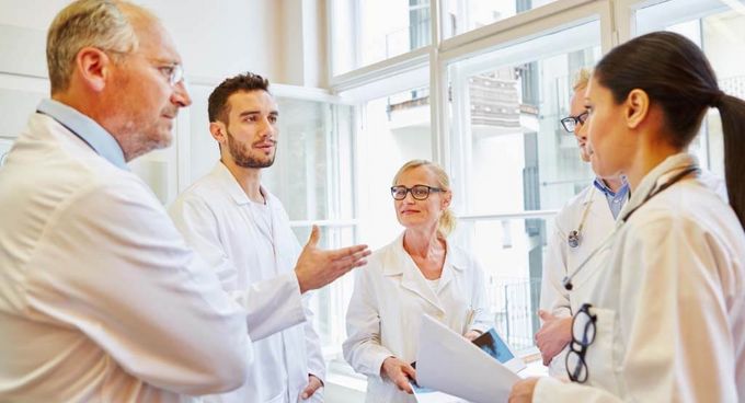 Ein Team aus unterschiedlich erfahrenen Ärztinnen und Ärzten diskutiert miteinander